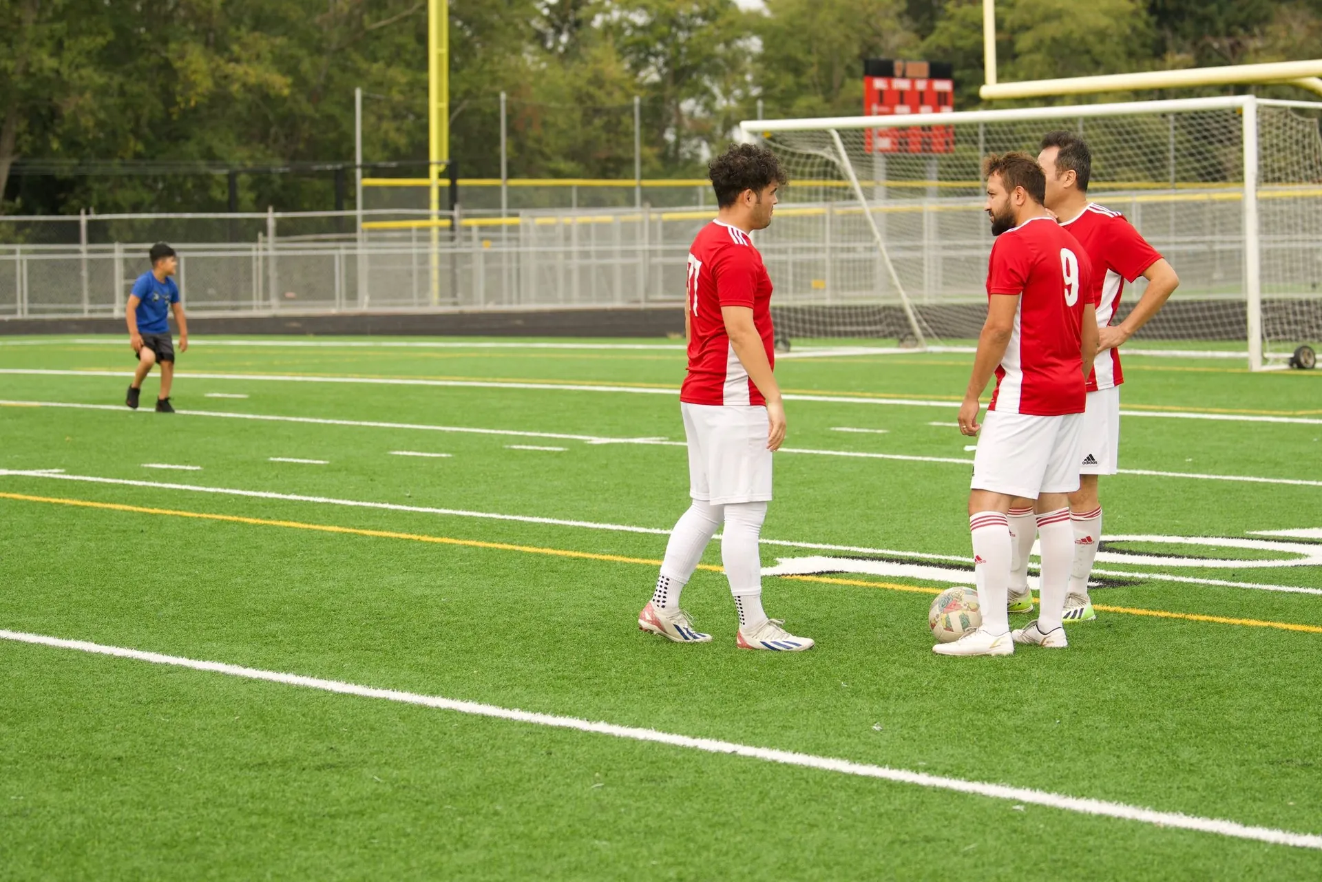 Players setting up a free kick