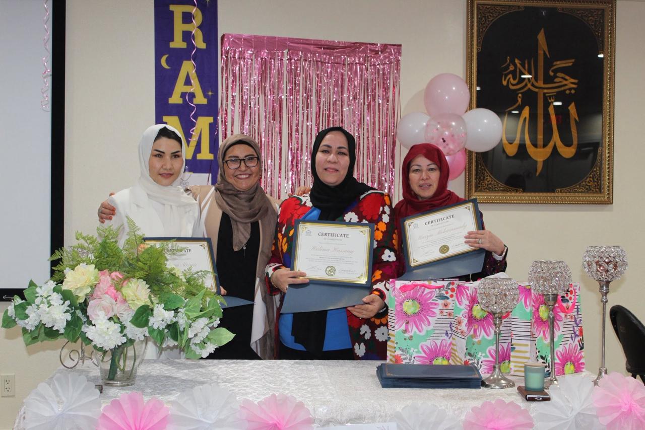 Graduates holding their swimming program certificates at the celebration ceremony